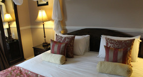 Bedside lamps and furnishings in the four-poster room