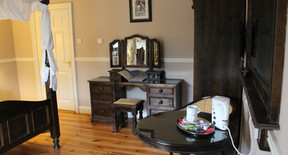 The four-poster room seen from the doorway